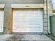 Attached single-car garage with a white door, offering convenient parking and storage at 6233 Dewdrop Way # 6233, Tampa, FL 33617