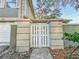 Decorative entrance gate with concrete pillars, enhancing privacy and curb appeal at 6233 Dewdrop Way # 6233, Tampa, FL 33617