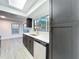 Modern kitchen has stainless appliances, quartz countertops and a skylight at 6233 Dewdrop Way # 6233, Tampa, FL 33617