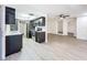 Modern kitchen featuring stainless steel appliances and sleek, dark cabinetry, flowing into a brightly lit open floor plan at 6233 Dewdrop Way # 6233, Tampa, FL 33617
