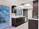 Modern kitchen featuring dark cabinets, stainless steel appliances, bright countertops, and a window at 6233 Dewdrop Way # 6233, Tampa, FL 33617