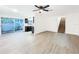 Bright living room features new flooring and a sliding glass door leading to the patio at 6233 Dewdrop Way # 6233, Tampa, FL 33617