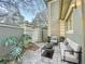 Relaxing outdoor patio with comfortable seating and a charming courtyard gate at 6233 Dewdrop Way # 6233, Tampa, FL 33617