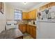 Functional kitchen features wood cabinets, standard appliances, and tile backsplash at 645 16Th S Ave, St Petersburg, FL 33701