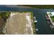 Stunning aerial view of vacant lot along canal, featuring private dock and serene waterfront scenery at 7034 Southwind Dr, Hudson, FL 34667