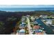 An aerial view of a home featuring a private pool, lush greenery, and a tranquil neighborhood setting at 7034 Southwind Dr, Hudson, FL 34667