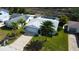 An aerial view of a home with a well-manicured lawn and a two-car garage at 7034 Southwind Dr, Hudson, FL 34667