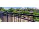 Backyard features manicured green grass, black metal fence, and privacy landscaping, offering a secure and private outdoor space at 7034 Southwind Dr, Hudson, FL 34667