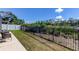 View of fenced-in backyard with grassy area and patio seating, showcasing a private outdoor space at 7034 Southwind Dr, Hudson, FL 34667