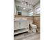 This bathroom features a vanity with a white countertop, a large mirror, and tile flooring at 7034 Southwind Dr, Hudson, FL 34667