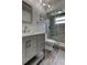 Beautiful bathroom with gray vanity, modern sink and stylish tile shower with glass door at 7034 Southwind Dr, Hudson, FL 34667
