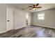 Bedroom featuring ceiling fan, window, new plank flooring, and access to a full bathroom at 7034 Southwind Dr, Hudson, FL 34667