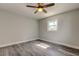 Bedroom with sleek wood flooring, ceiling fan, and natural light at 7034 Southwind Dr, Hudson, FL 34667