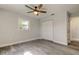This light-filled bedroom features wood floors, a ceiling fan, and closet at 7034 Southwind Dr, Hudson, FL 34667