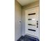 The home's modern front door has horizontal windows allowing natural light into the home at 7034 Southwind Dr, Hudson, FL 34667