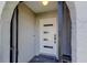 Close up of the modern front door with horizontal windows allowing natural light into the home at 7034 Southwind Dr, Hudson, FL 34667