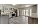 A view of the updated kitchen with modern appliances and gray cabinets and backsplash at 7034 Southwind Dr, Hudson, FL 34667