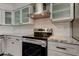 Updated kitchen with stainless steel appliances, granite countertops, and white subway tile backsplash at 7034 Southwind Dr, Hudson, FL 34667