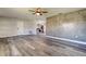 The living room has gray waterproof floors and a decorative accent wall with access to the kitchen at 7034 Southwind Dr, Hudson, FL 34667