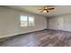 The living room features gray waterproof floors, a new window and a ceiling fan at 7034 Southwind Dr, Hudson, FL 34667