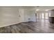 Living room features gray waterproof floors with access to the kitchen at 7034 Southwind Dr, Hudson, FL 34667