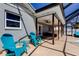 Outdoor patio with blue furniture, ceiling fan, and view of the pool and bar at 7034 Southwind Dr, Hudson, FL 34667