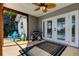 An inviting screened-in porch with ceiling fan, furniture and view of the pool at 7034 Southwind Dr, Hudson, FL 34667