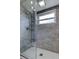 Shower featuring gray tiling with white subway tile flooring and a multi-setting shower head at 7034 Southwind Dr, Hudson, FL 34667