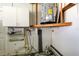 Utility area with a water heater and storage cabinets at 7034 Southwind Dr, Hudson, FL 34667