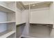 Walk-in closet with custom shelving and hanging racks at 7034 Southwind Dr, Hudson, FL 34667
