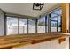 Outdoor wet bar in the screened in patio, featuring wood countertop and white siding at 7034 Southwind Dr, Hudson, FL 34667