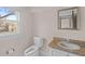 Bathroom featuring a vanity with granite top, toilet, mirror, and window at 709 W Azeele St, Tampa, FL 33606