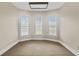Bedroom featuring three windows, carpeted floors, and neutral walls at 709 W Azeele St, Tampa, FL 33606