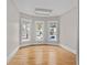 Cozy bedroom with three windows, neutral walls, hardwood floors, and natural light creating a relaxing atmosphere at 709 W Azeele St, Tampa, FL 33606