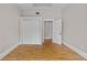 Bedroom with hardwood floors and neutral walls features a closet and a doorway to another room at 709 W Azeele St, Tampa, FL 33606