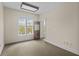 Bright bedroom with neutral tones, a large window, and an adjacent doorway at 709 W Azeele St, Tampa, FL 33606
