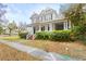 Charming two-story home with a large front porch, lush landscaping, and classic architectural details at 709 W Azeele St, Tampa, FL 33606