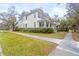 Charming two-story home with a large front porch, manicured lawn, and mature trees at 709 W Azeele St, Tampa, FL 33606