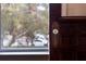 Close-up of an antique front door with glass knob and detailed wood trim at 709 W Azeele St, Tampa, FL 33606