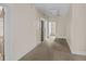 Long hallway featuring carpeted flooring, neutral walls, and multiple doorways at 709 W Azeele St, Tampa, FL 33606