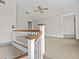 Upstairs hallway with white railings and carpet flooring leads to the upper levels of the home at 709 W Azeele St, Tampa, FL 33606