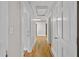 Hallway with original hardwood flooring and white trim throughout leads to other rooms in the home at 709 W Azeele St, Tampa, FL 33606