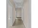 Hallway featuring carpeted flooring, neutral paint, and multiple doorways at 709 W Azeele St, Tampa, FL 33606