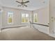 Bright hallway featuring a carpeted floor, multiple windows with natural light, and a ceiling fan at 709 W Azeele St, Tampa, FL 33606