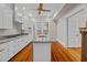 Bright kitchen with stainless steel appliances, granite countertops, island sink, and hardwood floors at 709 W Azeele St, Tampa, FL 33606