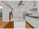 Modern kitchen with stainless steel appliances, island, light fixtures, granite countertops, and neutral cabinets at 709 W Azeele St, Tampa, FL 33606