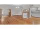 Light-filled living room with hardwood floors, fireplace, and elegant chandelier, creating a warm and inviting space at 709 W Azeele St, Tampa, FL 33606