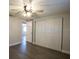 Bedroom offers wood-look floors, ceiling fan, and closet at 7144 Fairfax Dr, Port Richey, FL 34668