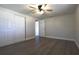 Comfortable bedroom with spacious closet and wood-look flooring at 7144 Fairfax Dr, Port Richey, FL 34668