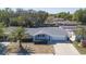 Aerial view of home showing landscaping, a palm tree, driveway, and neighborhood at 7144 Fairfax Dr, Port Richey, FL 34668